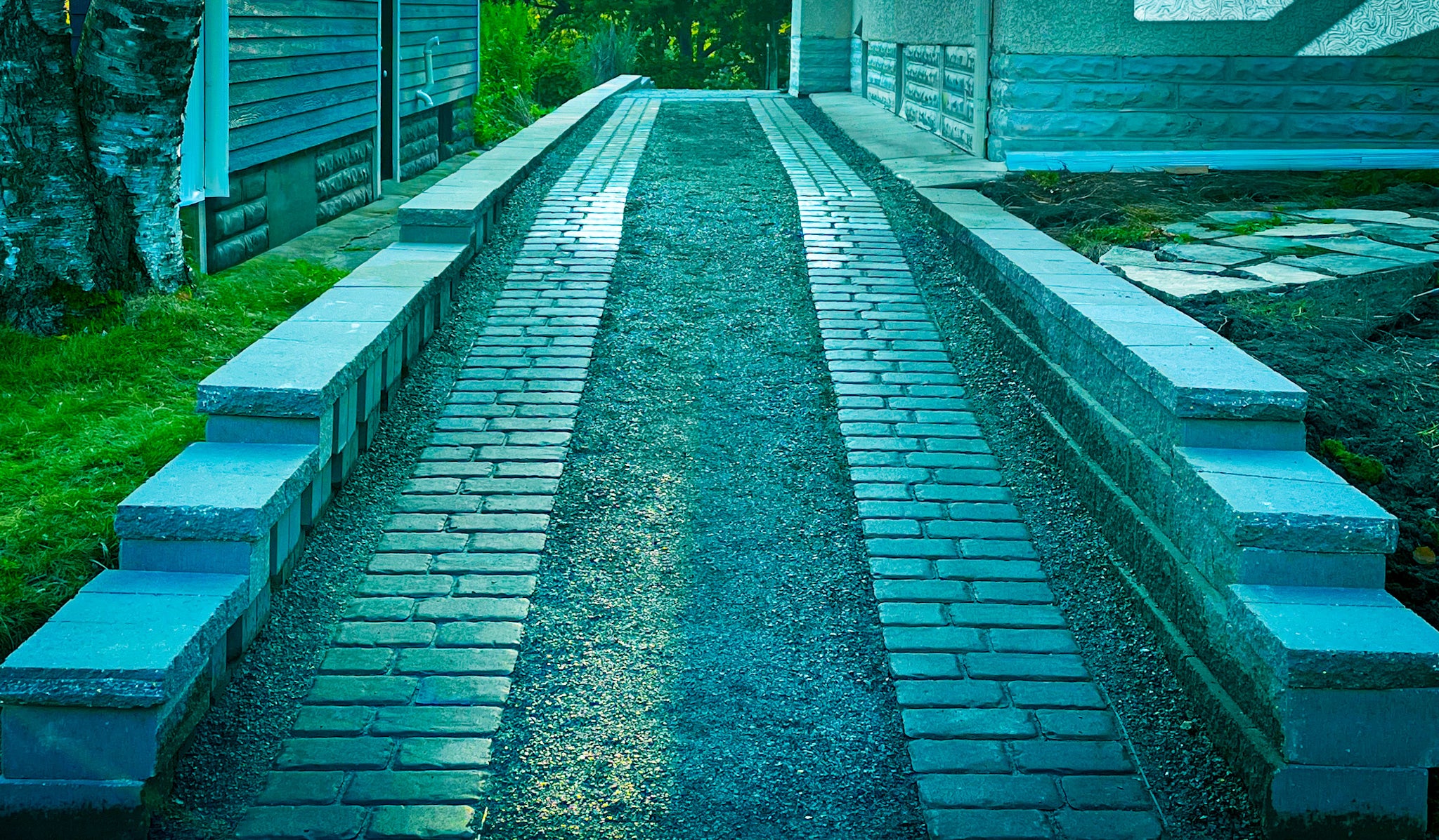 Custom ribbon driveway and brick paver approach by Elzo Landscape in Minneapolis