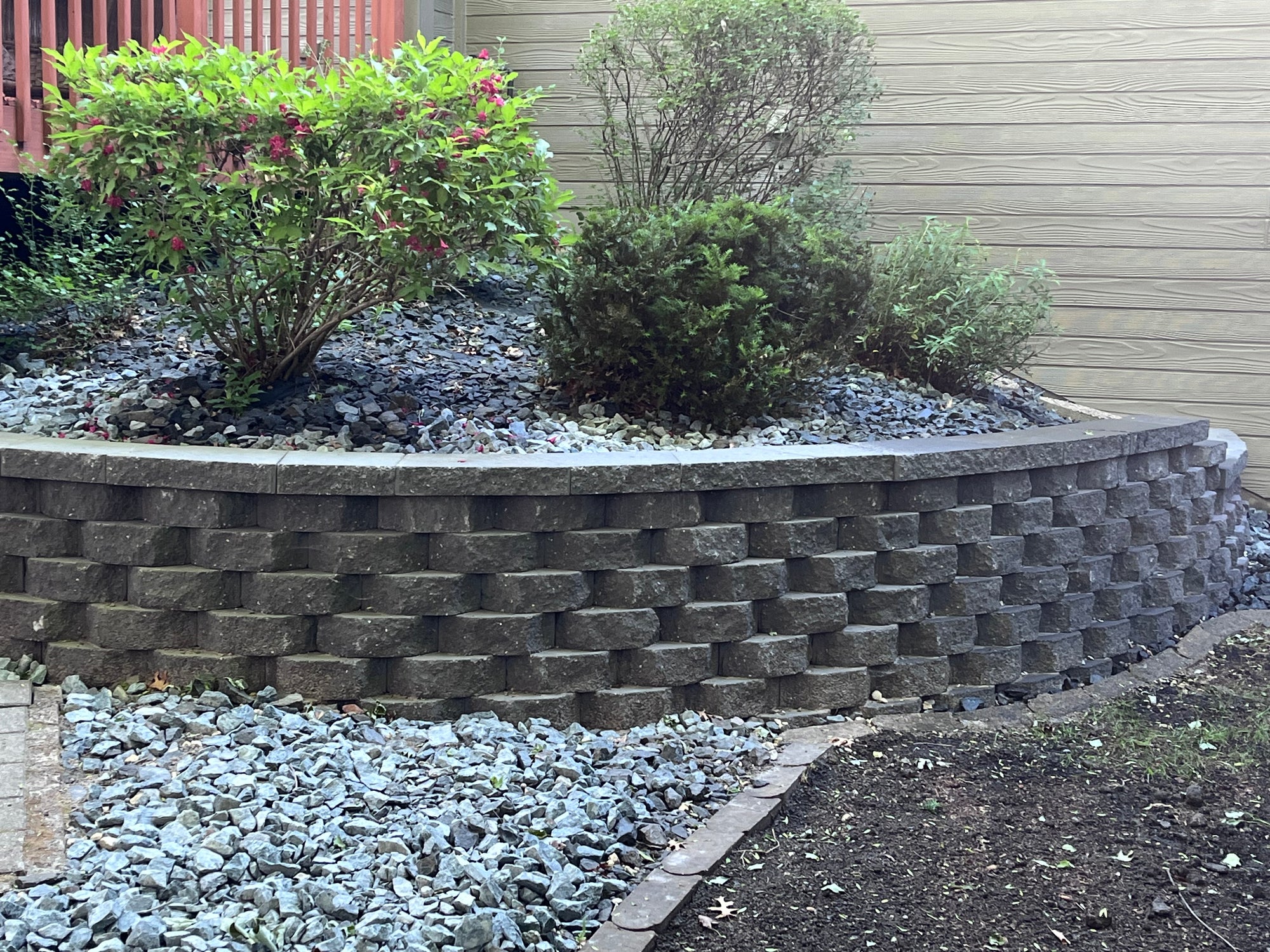 Regraded backyard with fresh grass seed and stone features in Elk River