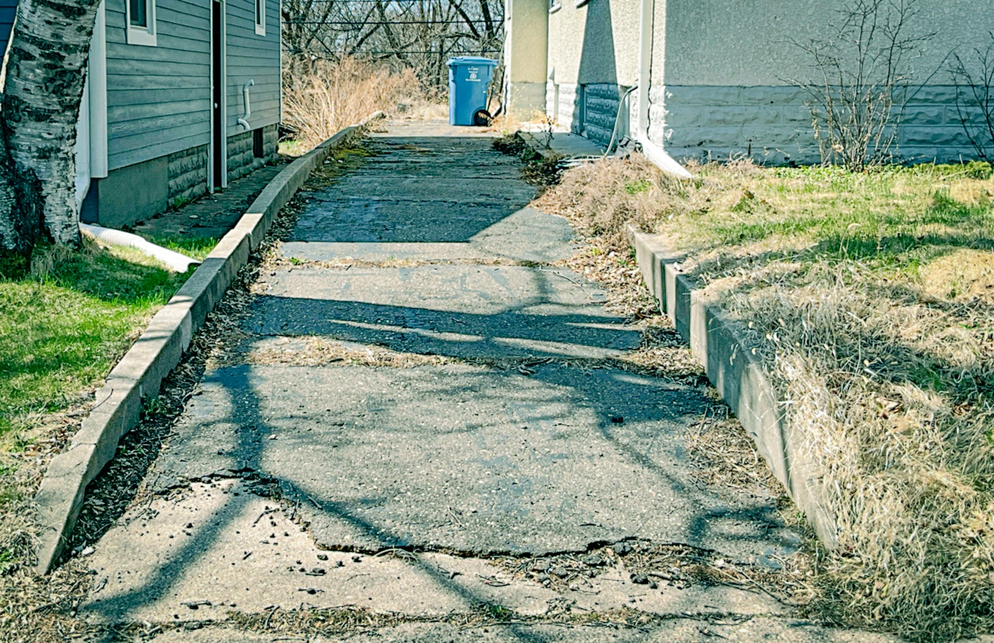 Before: Worn asphalt driveway in Bryn Mawr Minneapolis