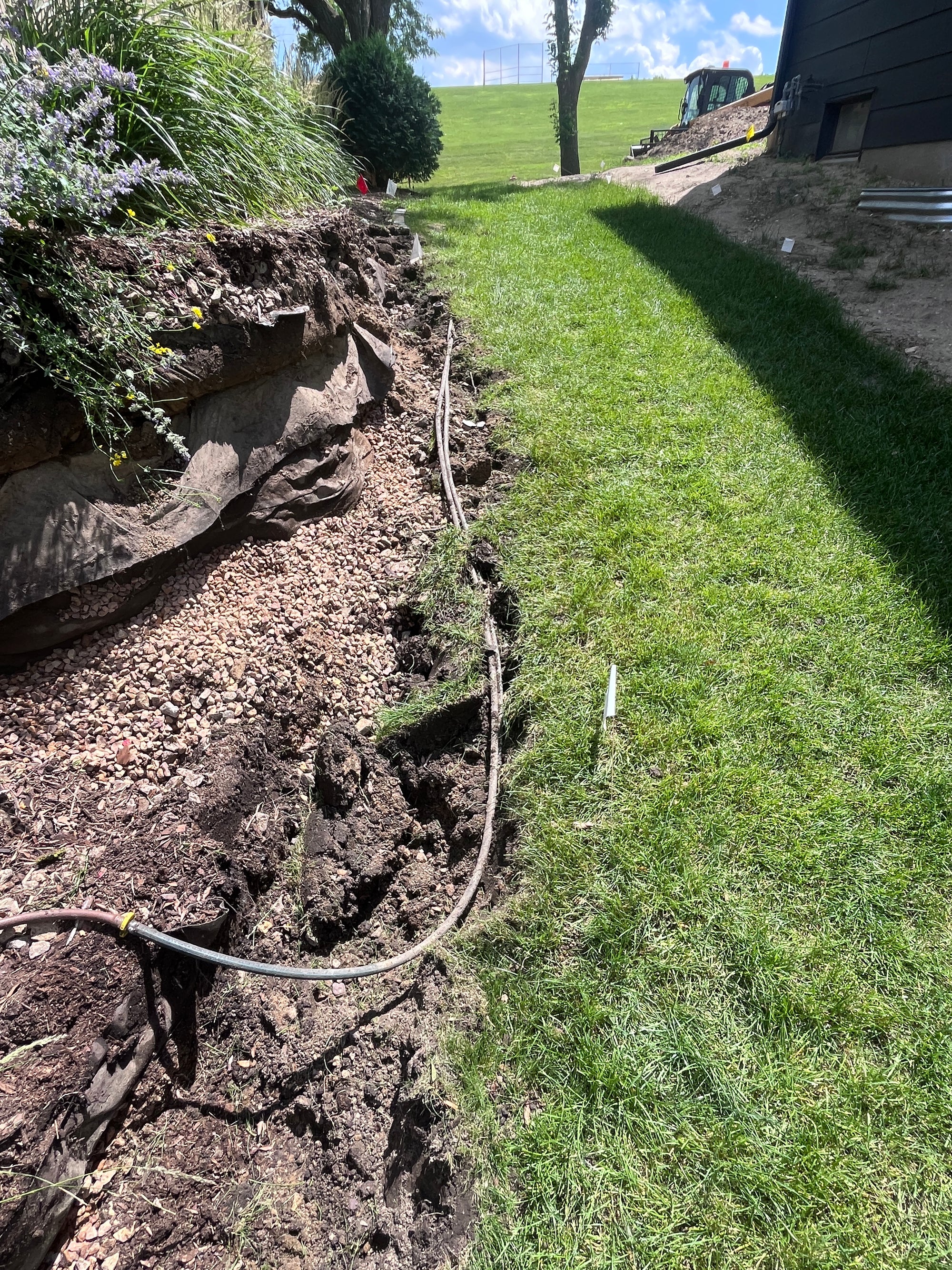 Drainage trench installed beside an existing lawn