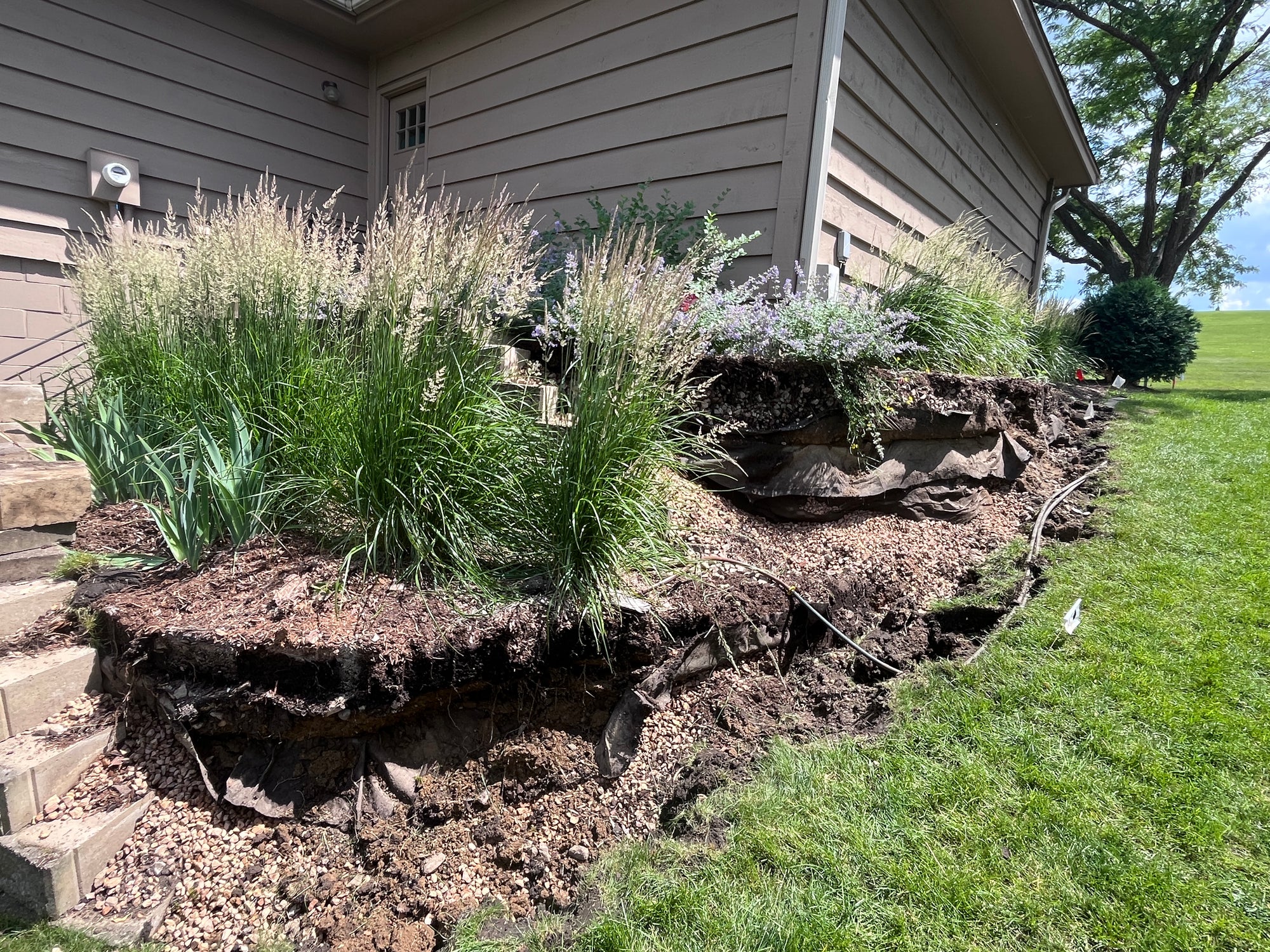 Retaining wall demolition in progress in West Bloomington Minneapolis before rebuild
