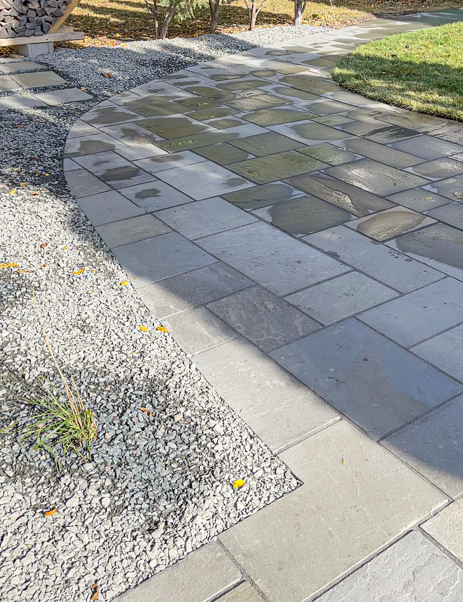 Custom bluestone patio in Minneapolis with clean edge definition, structured planting beds, and cohesive outdoor living design.